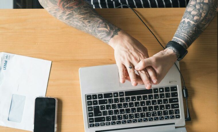 Small business owner comparing Facebook ads and Google Ads campaign results on a laptop