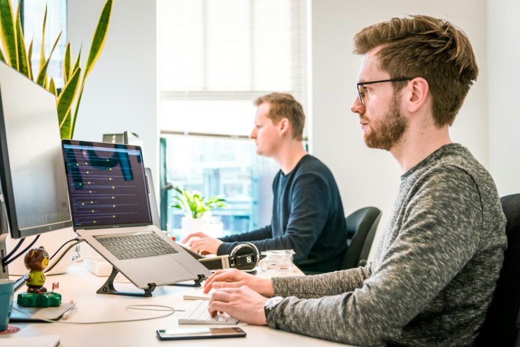 Web development team working together on laptops in an office