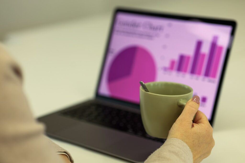 Laptop showing website analytics and SEO audit data on a desk