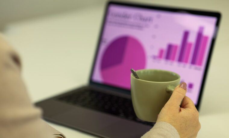 Laptop showing website analytics and SEO audit data on a desk