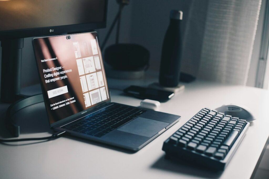 Web developer working on a website layout on a laptop at a desk