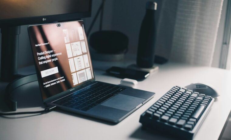 Web developer working on a website layout on a laptop at a desk