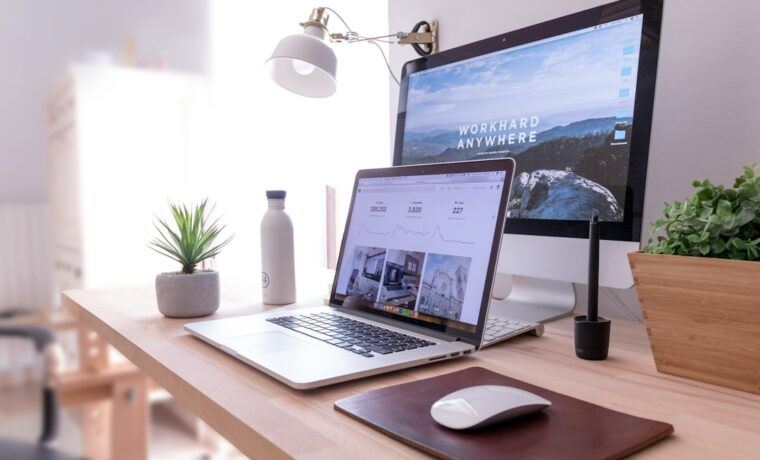 Laptop on a desk showing website design work, illustrating the WordPress vs Shopify choice
